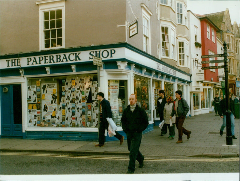 A group of men in Virginia gather outside a paperback shop. - Vintage Photograph