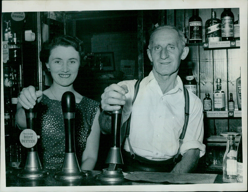 A bar stocked with a variety of alcoholic drinks. - Vintage Photograph