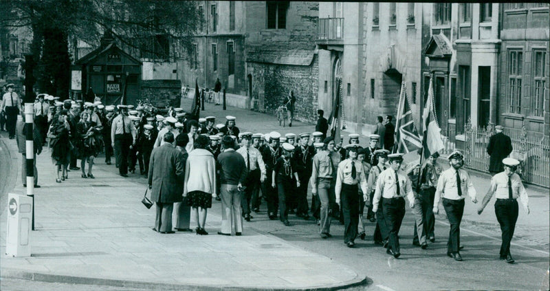 A student displays their exam results in front of a crowd. - Vintage Photograph