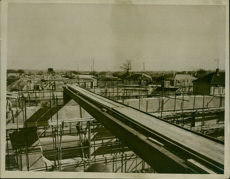 Construction workers are seen on the Eas tem By-pass hiltlemore Slyover 86 in progress. - Vintage Photograph