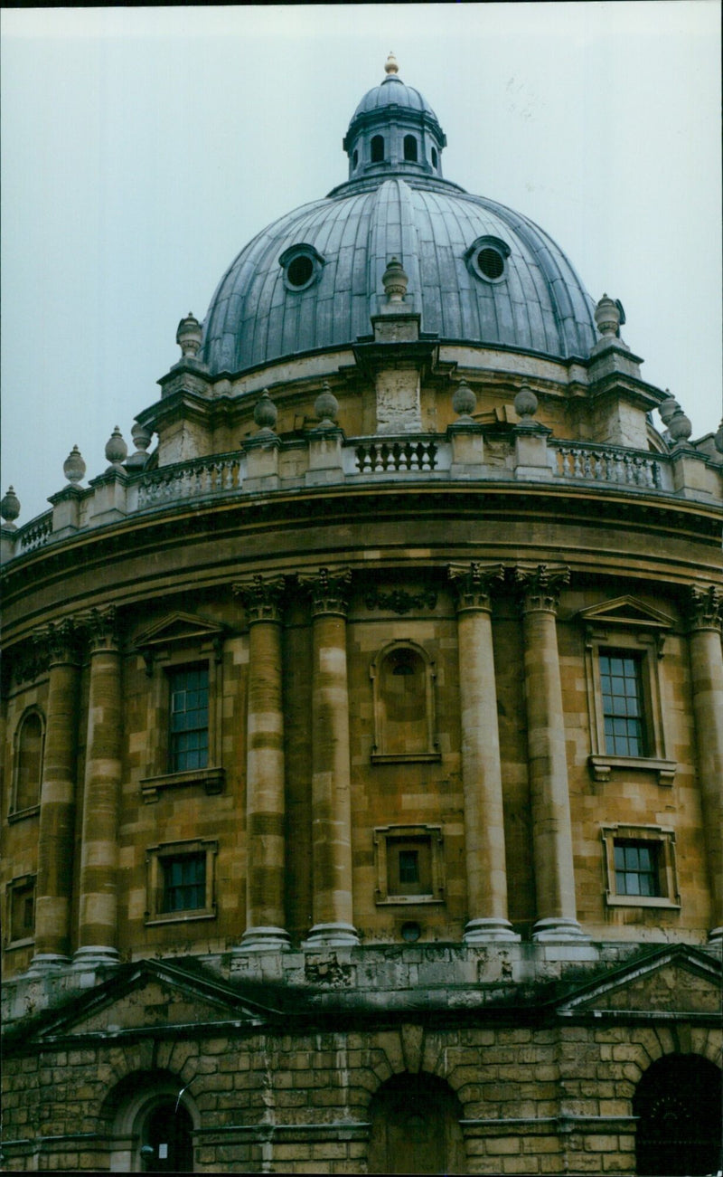 Oxford University's iconic Radcliffe Camera stands illuminated against the night sky. - Vintage Photograph