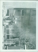 A man taking a photograph with a film camera. - Vintage Photograph