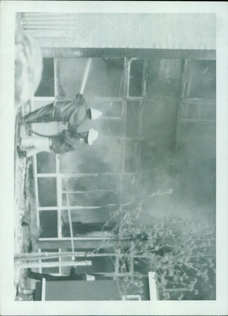 A man taking a photograph with a film camera. - Vintage Photograph