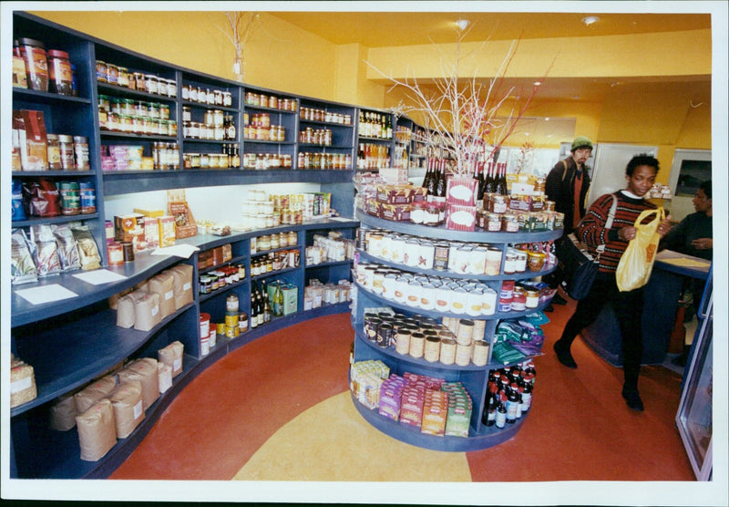 Noz Mngxitama stocking shelves at a Uhuro Wholefoods store in Oxford. - Vintage Photograph