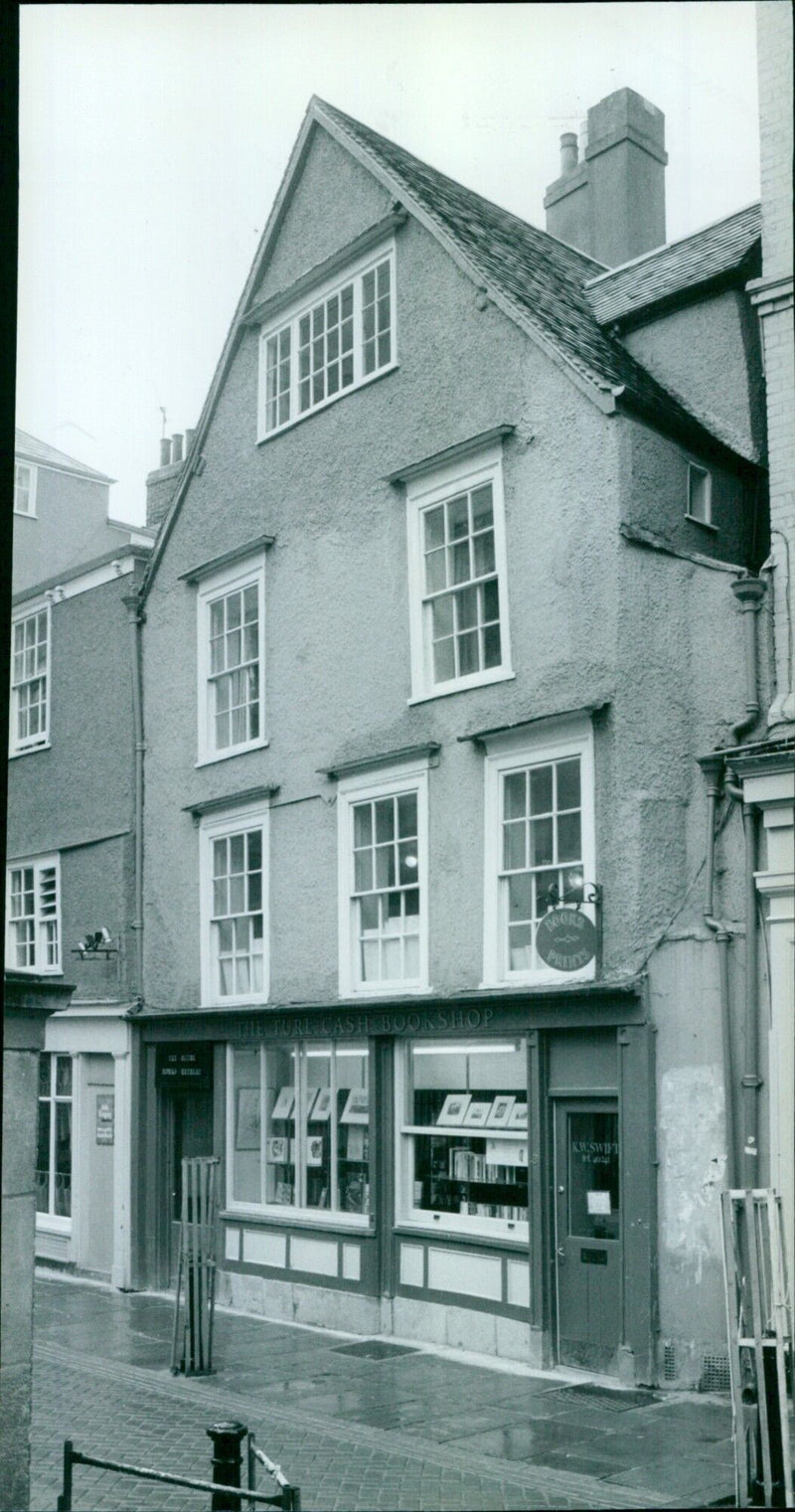 A jeep parked outside a bookshop filled with 4800 books. - Vintage Photograph