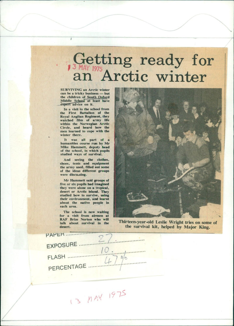 A 13-year-old student tries on Arctic survival equipment with help from a Major of the Royal Anglian Regiment. - Vintage Photograph