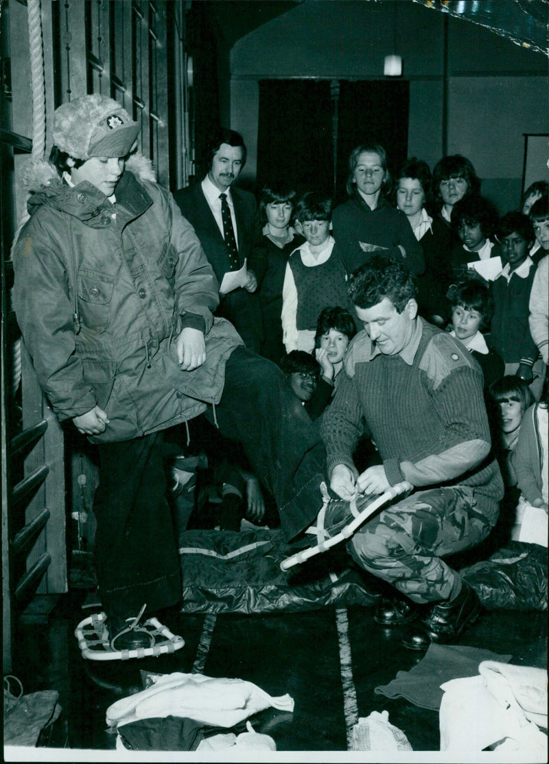 A 13-year-old student tries on Arctic survival equipment with help from a Major of the Royal Anglian Regiment. - Vintage Photograph