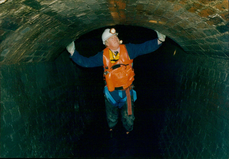 Ken Weeks, Sewer Age Manager for Thame, Wato, inspects a sewer in Oxford, England. - Vintage Photograph