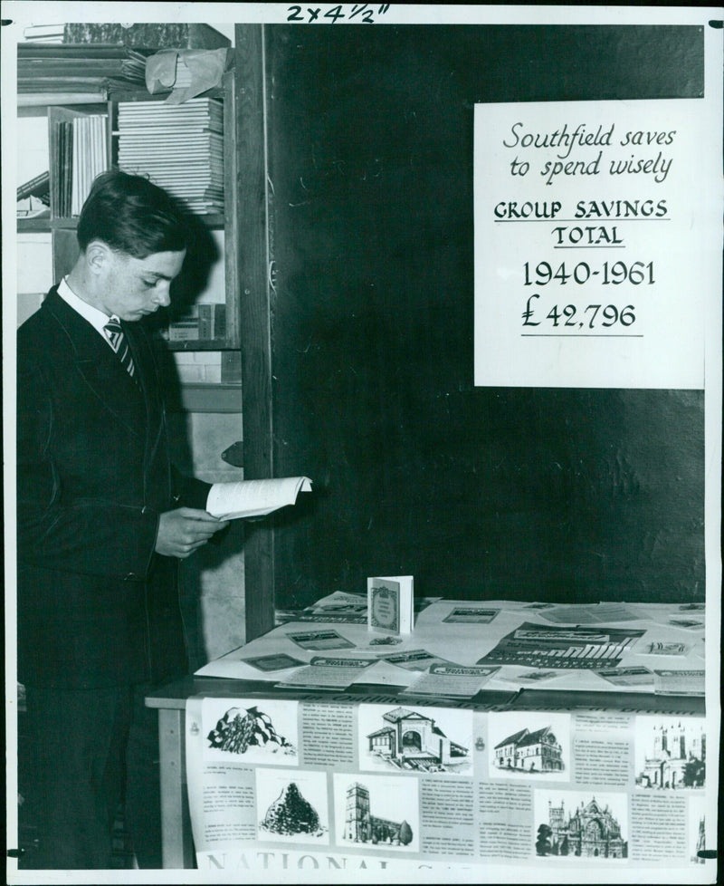 Members of Southfield School Group examine the various forms of saving on display at their Savings Exhibition. - Vintage Photograph