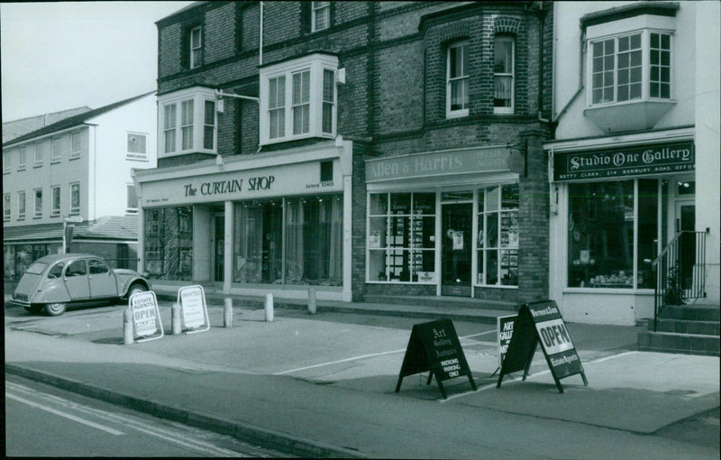 A variety of businesses line a street in Summertown, Oxford. - Vintage Photograph