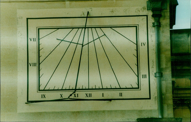 Ken Ayris stands in front of two sundials at Christ Church, Oxford on August 12, 1999. - Vintage Photograph