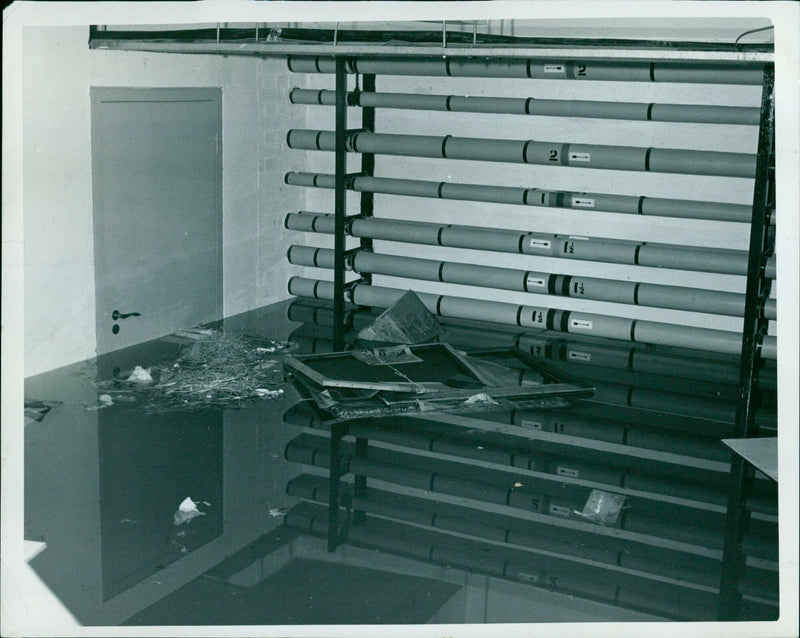 Floodwater reaches the door handle of a St. Catherine's College building. - Vintage Photograph