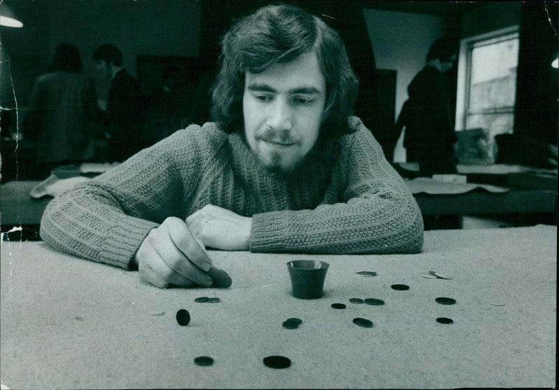 Phillip Shearman, a student from Oxford, getting ready for the annual Oxford vs. Cambridge Tiddlywinks match. - Vintage Photograph