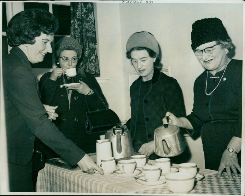 Mrs. M. Waters and Mrs. M. Joscelyn with the tea hostesses, Miss O. Tabor and Mrs. A. Read. - Vintage Photograph