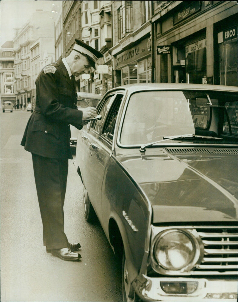 A traffic warden and a group of friends take part in a protest march in Oxford, England on July 16, 1985. - Vintage Photograph