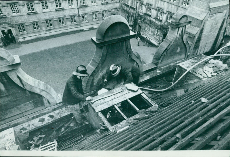 Undergraduates carry a painting to safety at Jesus College, Oxford after a fire. - Vintage Photograph