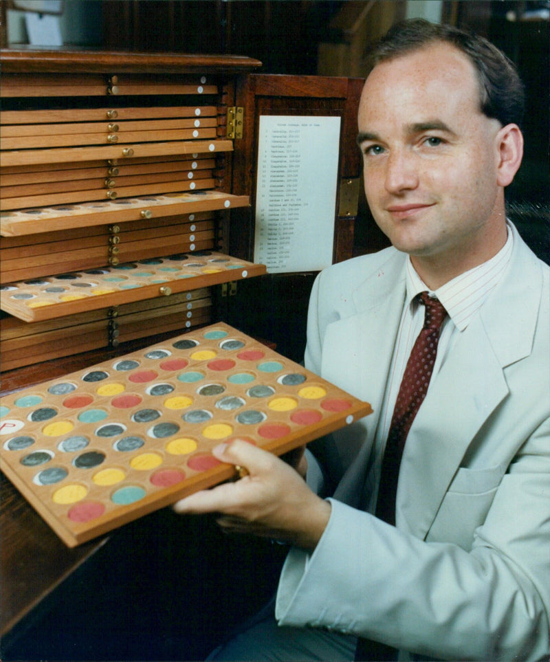 Mr. Chris Howgsgo pictured with ancient Roman coins at the Ashmolean Museum. - Vintage Photograph