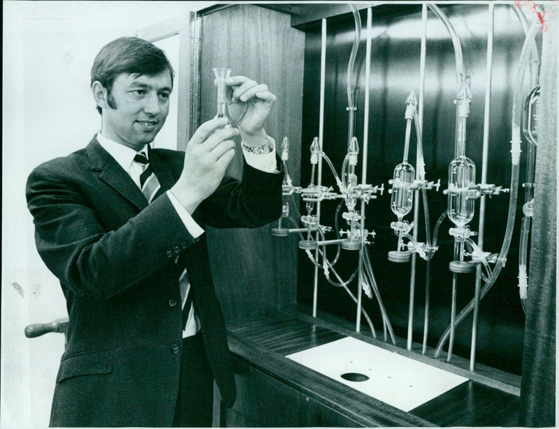 Deputy to Mr Dust using apparatus to test the accuracy of spirit measures in public houses. - Vintage Photograph