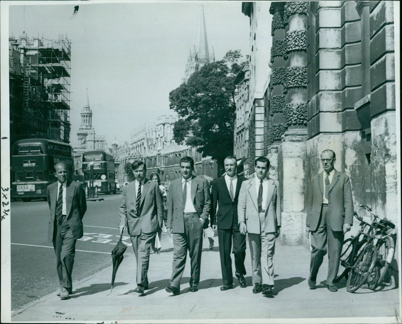 Four Uruguayan trade visitors enjoy the sights of Oxford's High Street, guided by two British officials. - Vintage Photograph