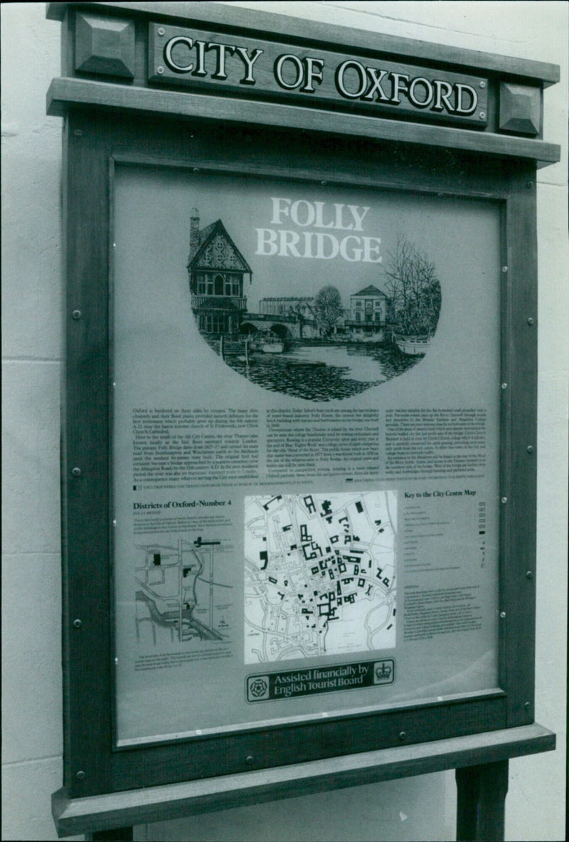 A tourist poses for a picture in front of Folly Bridge in the city of Oxford, England. - Vintage Photograph