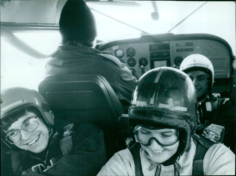 A group of students leaping off a wall and accelerating towards the ground. - Vintage Photograph