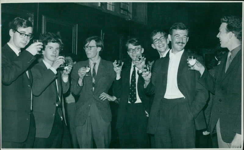 Students at Balliol College, Oxford raise their glasses in a toast to Si David Lindsay Kei at a retirement party. - Vintage Photograph