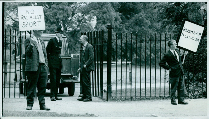 Supporters of the anti-apartheid movement gather outside the University Parks in Oxford, England, to protest a cricket match on the first day of W. Isaacs' XI, a South African touring team. - Vintage Photograph