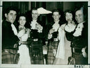 Six people gather to toast the poet Robert Burns. - Vintage Photograph