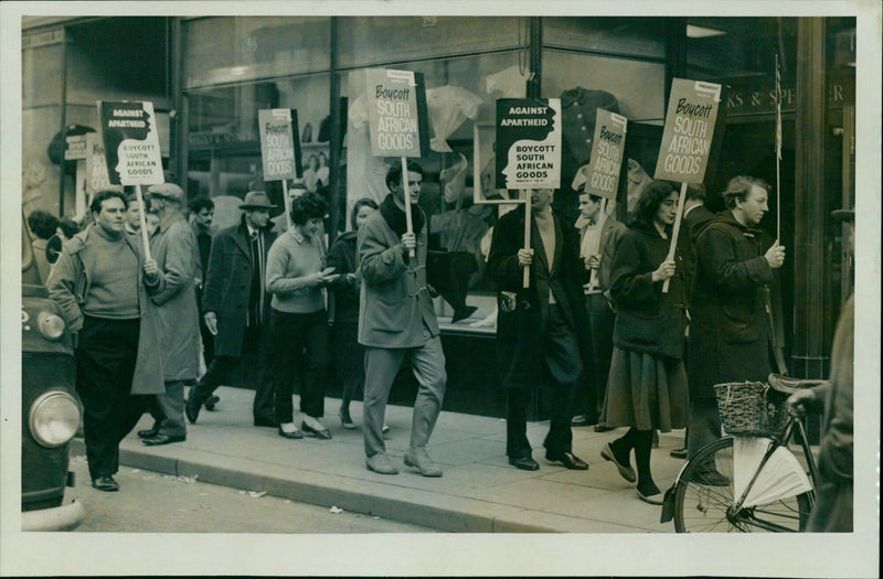 Anti-apartheid protesters march to boycott South African goods. - Vintage Photograph