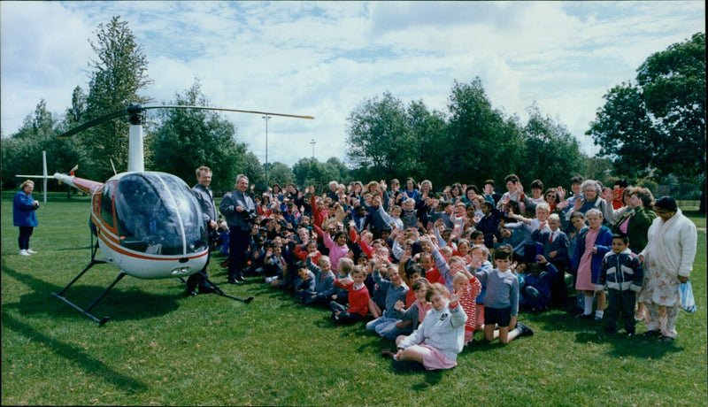 Pilots Rod Wood and Camerayan Malcolm Morgan land a helicopter to take photos of St Christophers 761 school kids. - Vintage Photograph