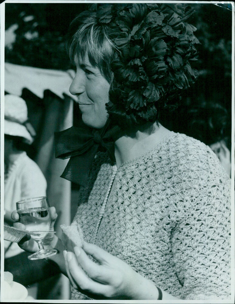 Miss A. M. Weddell wearing a unique blue hat of leaves held in place by a large bow at the Encaenia Garden Party in Oxford. - Vintage Photograph