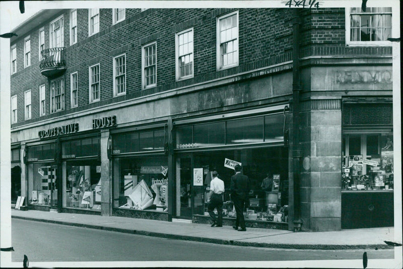 Customers shop for electrical appliances at a Co-op store. - Vintage Photograph