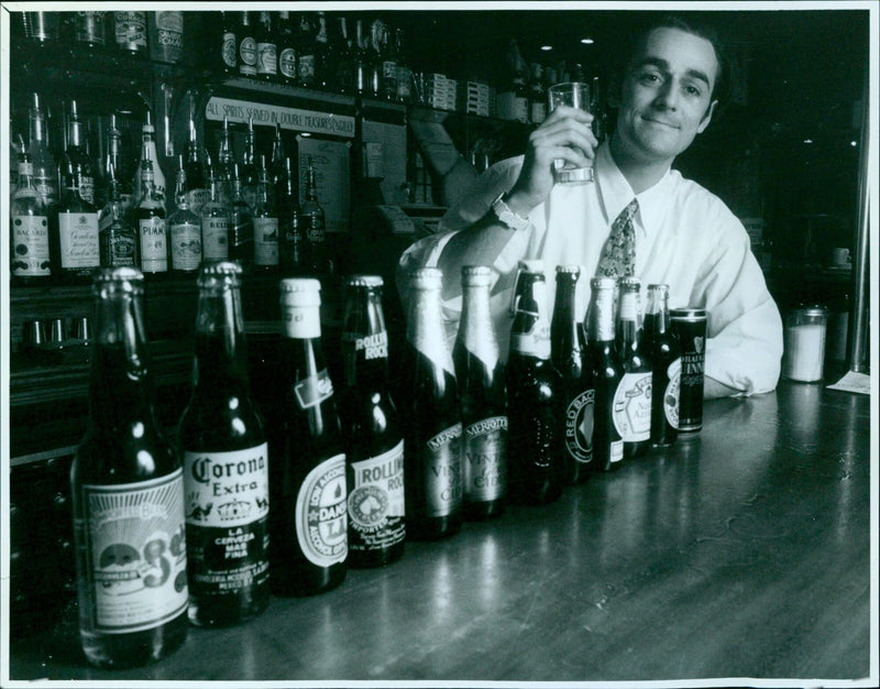 Stuart Edney, manager of the Blue Boar Pub in Oxford, is pictured with a selection of bottled beers. - Vintage Photograph