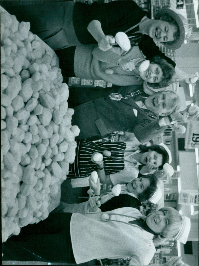 An elderly couple in their home with a basket of potatoes. - Vintage Photograph