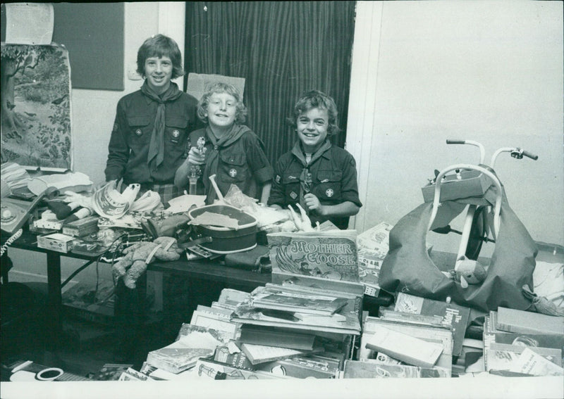 12-year-old Stuart Melville organizes a jumble sale to raise funds for a scout hut. - Vintage Photograph