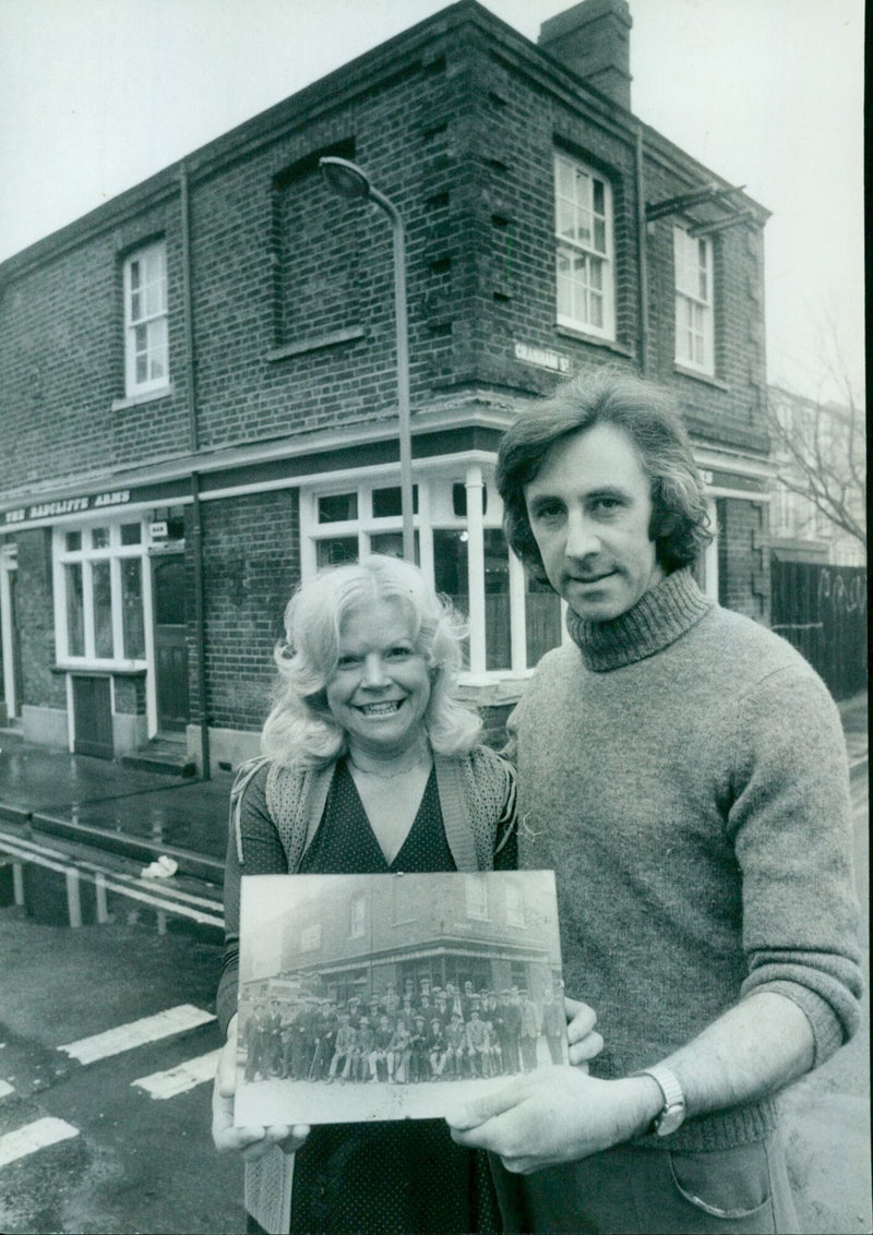 Bob Moore and his wife Ann stand outside the Radcliffe Arms pub in Oxford, England, where he is engaged in a legal battle to secure a Public Entertainment Licence. - Vintage Photograph