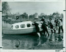 David Whiteman, assistant Scoutmaster, displays a 3x3 inch model of "Chetwyn U" in his front garden. - Vintage Photograph
