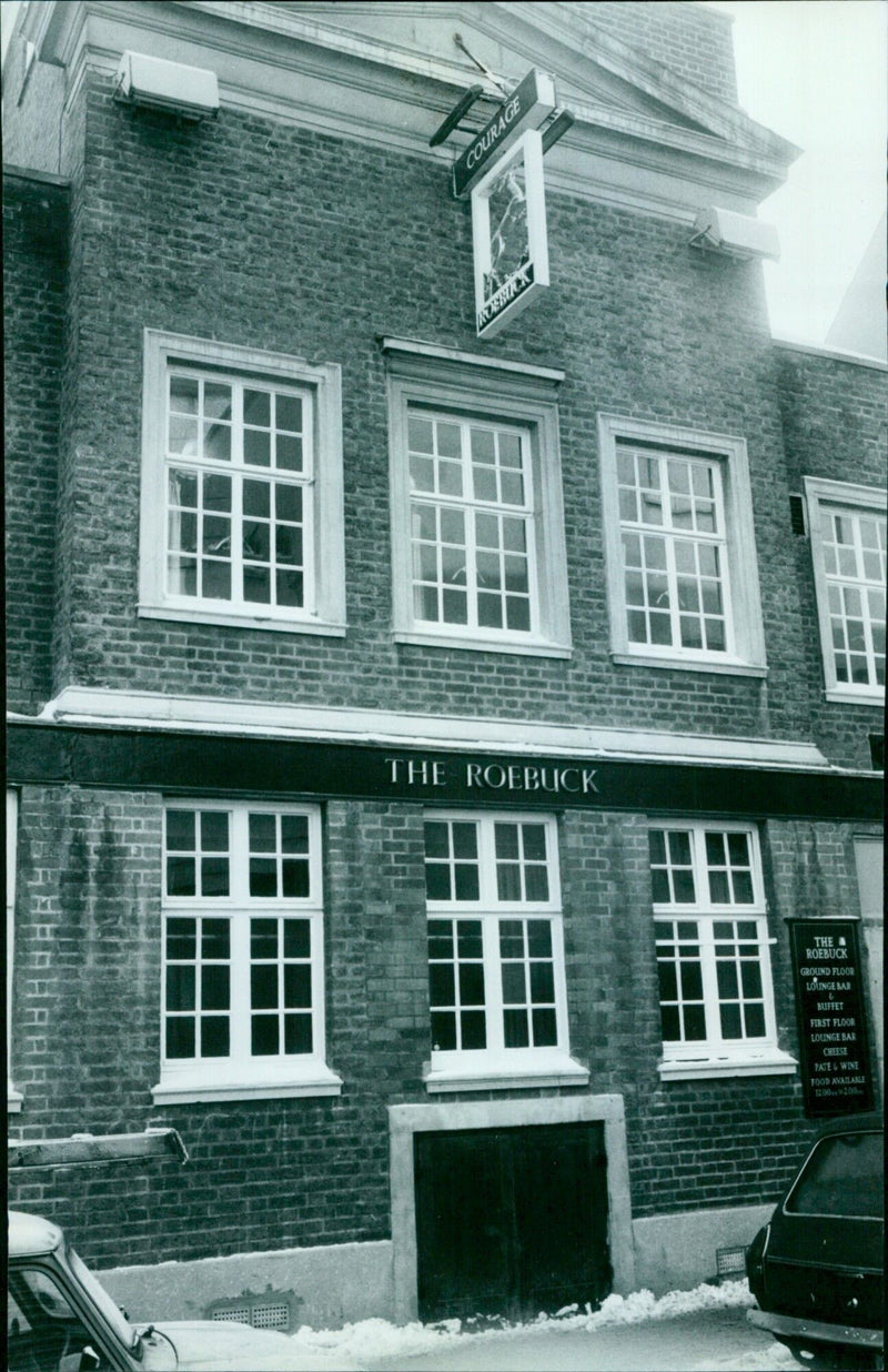 Customers enjoy food and drink at the Roebuck pub in Market Street, UK. - Vintage Photograph