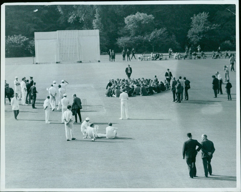 Demonstrators take over the square during a cricket match at Oxford University. - Vintage Photograph