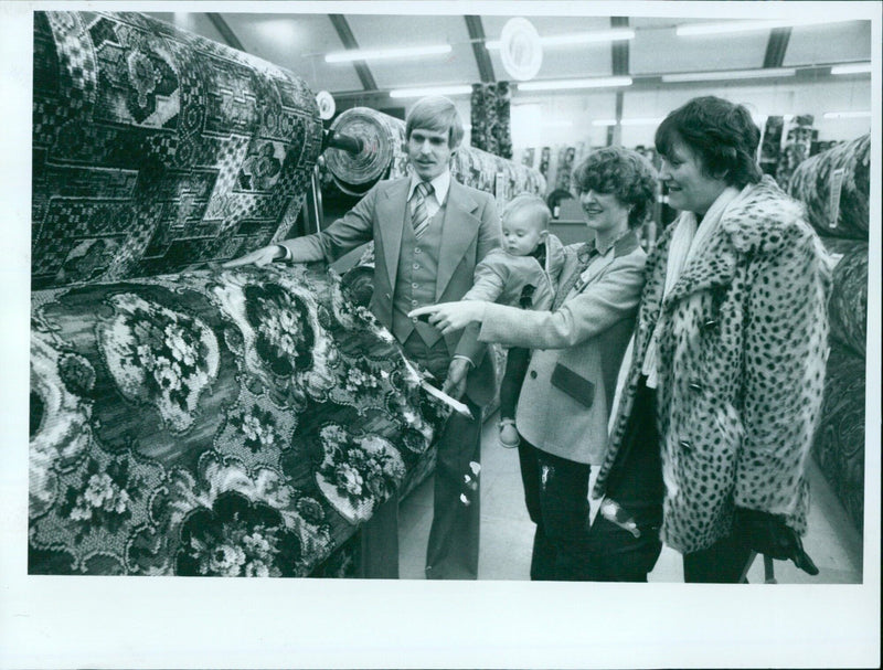 Sales Manager Paul Mentzel offers help and advice to potential customers in a Discount Carpets showroom. - Vintage Photograph