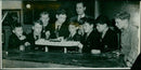 Boys of the Dragon School and their Science Master, Mr. G. Sommerhoff, demonstrate a model boat controlled by a remote radio. - Vintage Photograph