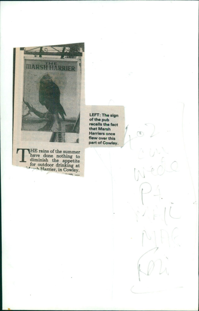 A sign commemorating the Marsh Harrier hangs outside Harrier pub in Cowley. - Vintage Photograph