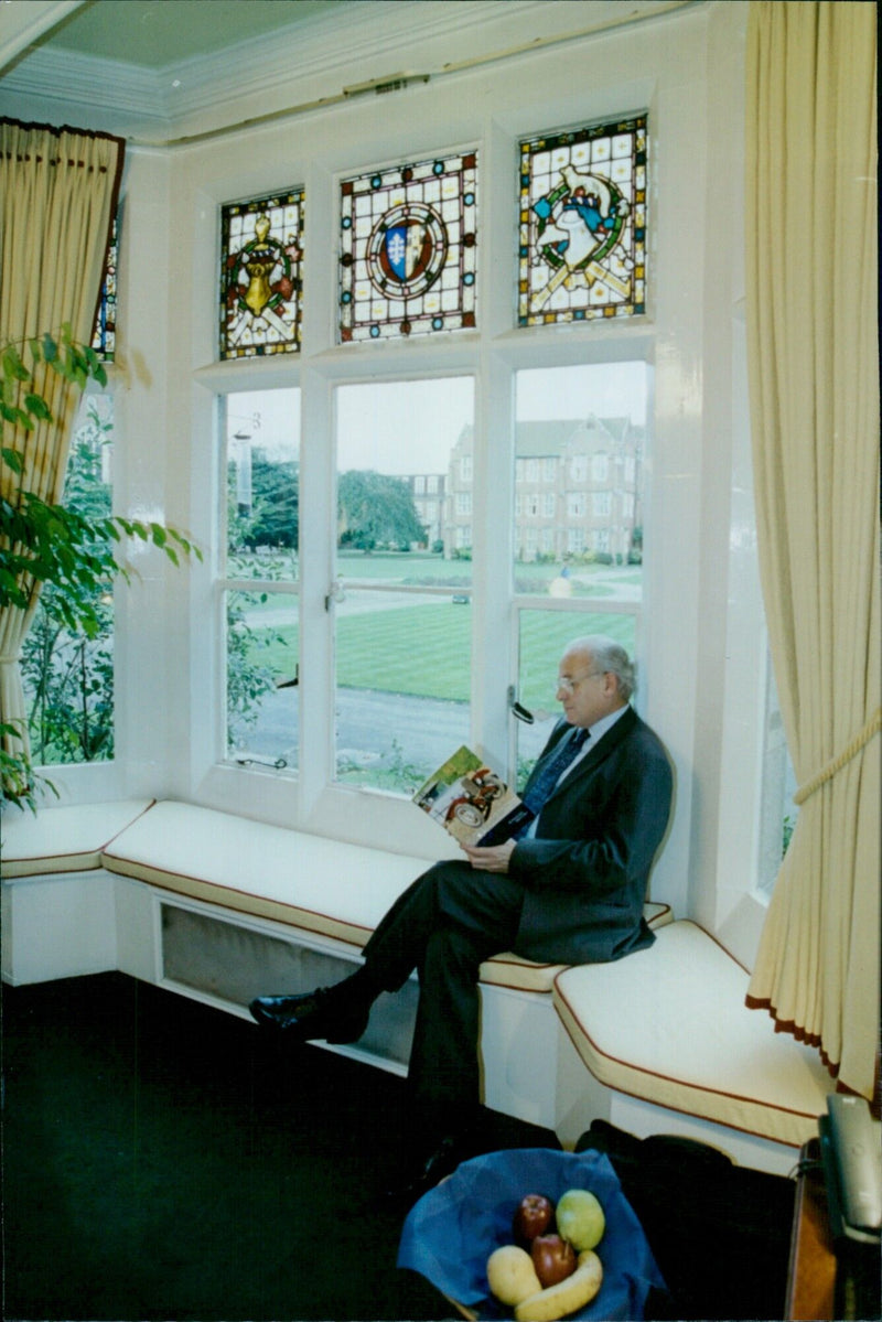 Warden of St Edwards School David Christie holds an auction brochure. - Vintage Photograph