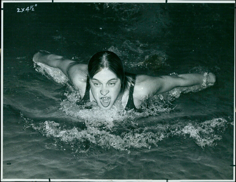 Judy Downing of Cheney Girls School beats Raymond Lloyd of Kingham Hill School in the 100 yard butterfly swim. - Vintage Photograph