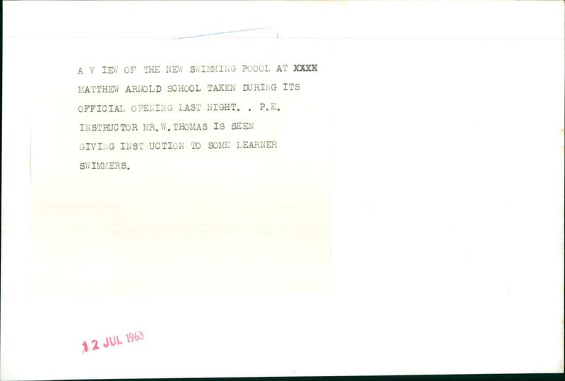 P.E. Instructor Mr. W. Thomas gives instruction to learner swimmers at the official opening of the new swimming pool at XXXH Matthew Arnold School. - Vintage Photograph