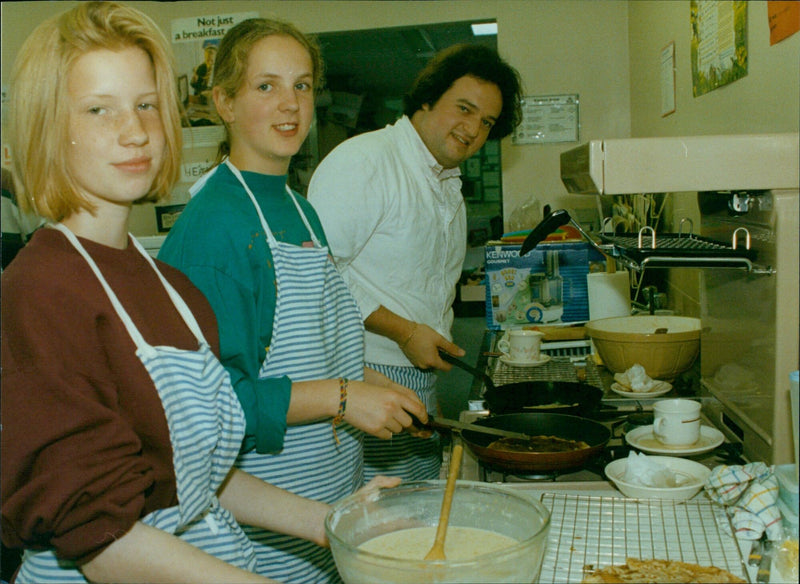 French chef Emerick Le Parathoenith teaches Sally Butler and Ellen Creaser at St. Frideswide School in Oxford. - Vintage Photograph