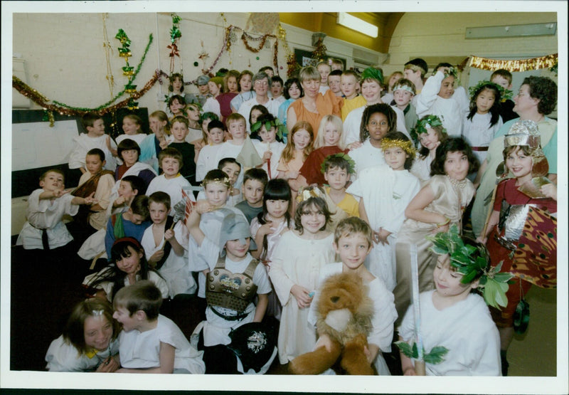 Roman soldiers accompany Mrs Atkinson as she reads from the scroll during an end of term party at Wolvercote First School. - Vintage Photograph