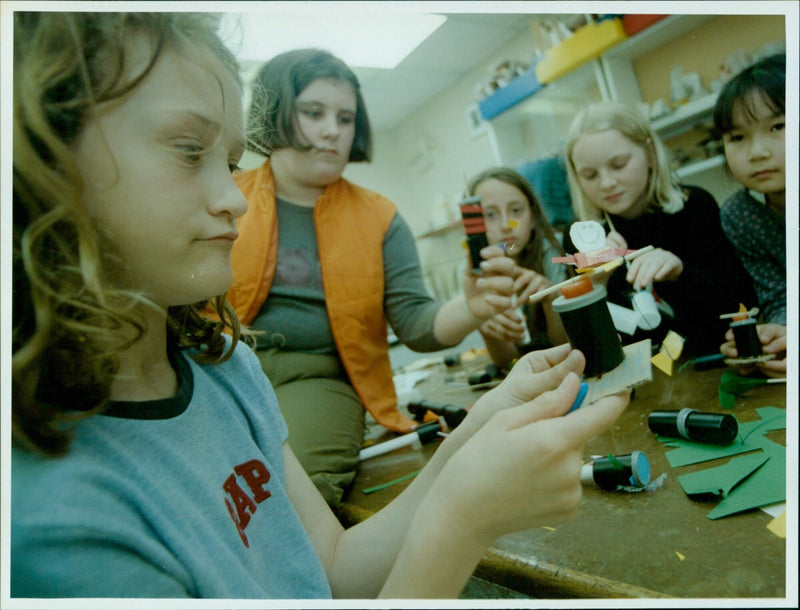 Toy maker Robert Race shows students the toys he has made from driftwood. - Vintage Photograph