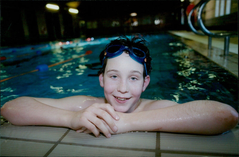 Henry Larkin, 13, takes part in a sponsored swim to benefit a South African township. - Vintage Photograph