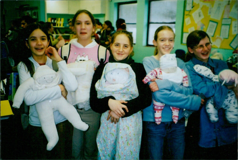 Five babies, from left to right, Jess, Katie, Charlotte, Anna, and Megan, enjoying a flour play session. - Vintage Photograph